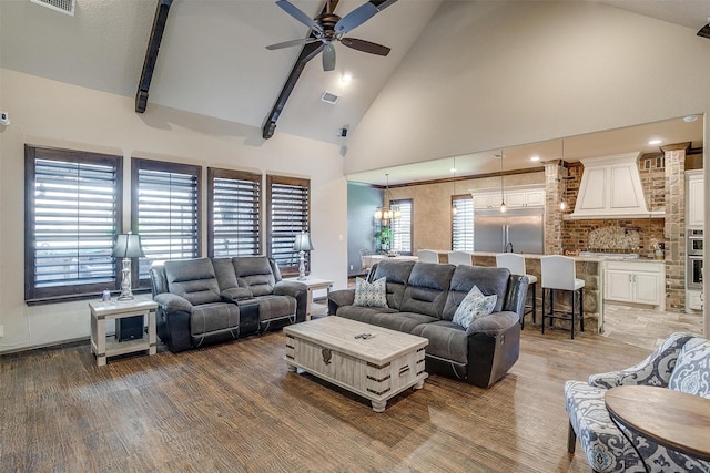 living room with beam ceiling, high vaulted ceiling, ceiling fan with notable chandelier, and hardwood / wood-style flooring