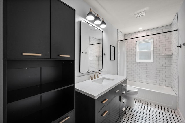 full bathroom with shower / bath combo with shower curtain, tile patterned floors, toilet, and vanity