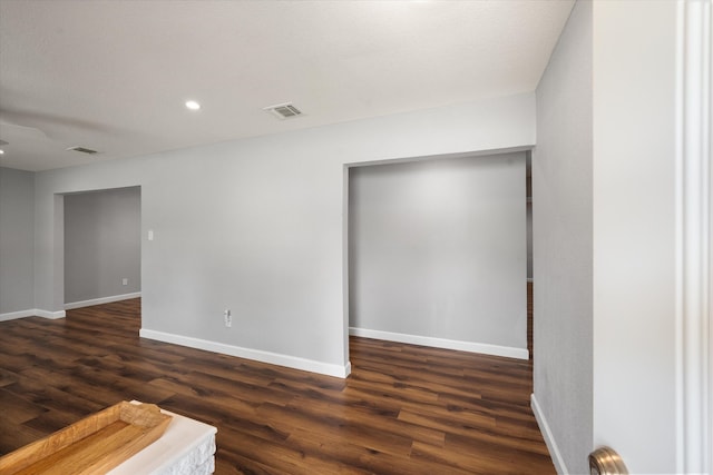 spare room with dark wood-type flooring