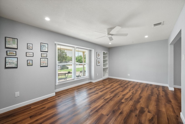 spare room with a textured ceiling, hardwood / wood-style flooring, and ceiling fan