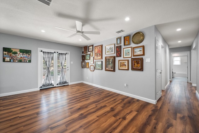 spare room with a wealth of natural light, ceiling fan, and dark hardwood / wood-style floors