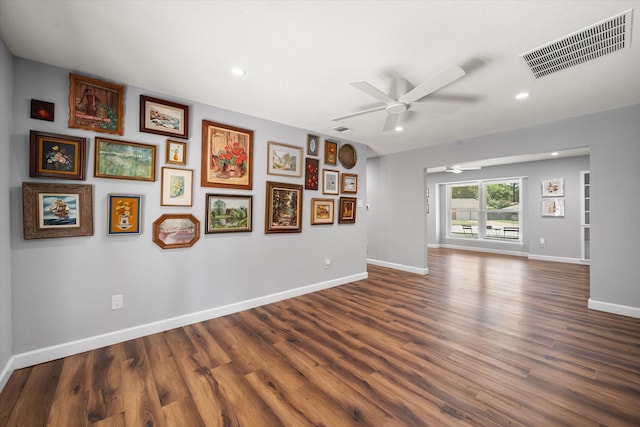 unfurnished living room featuring ceiling fan and hardwood / wood-style floors