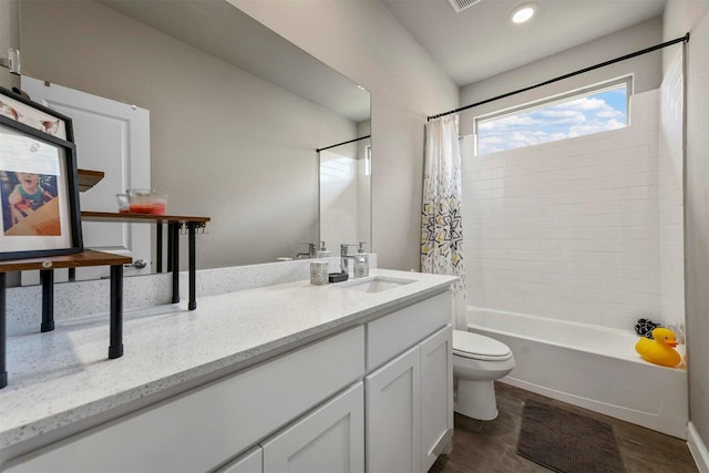 full bathroom featuring shower / bath combo with shower curtain, vanity, and toilet