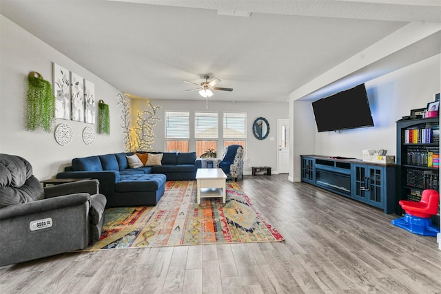 living room featuring hardwood / wood-style flooring and ceiling fan