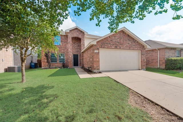 view of front of home featuring cooling unit, a garage, and a front lawn