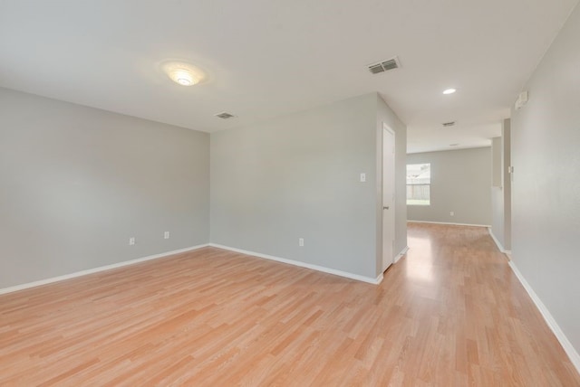 unfurnished room with light wood-type flooring