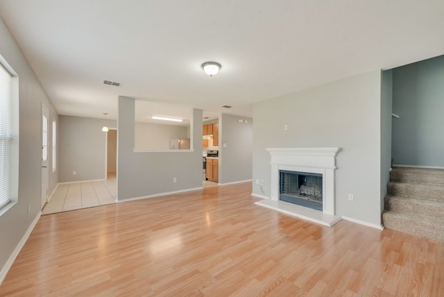 unfurnished living room with light hardwood / wood-style floors