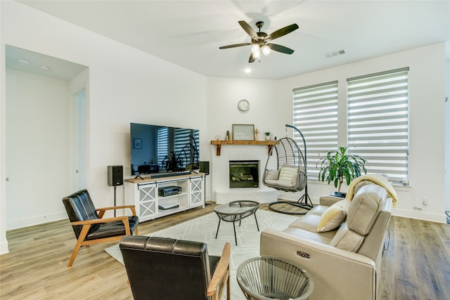 living room featuring plenty of natural light, light hardwood / wood-style flooring, and ceiling fan