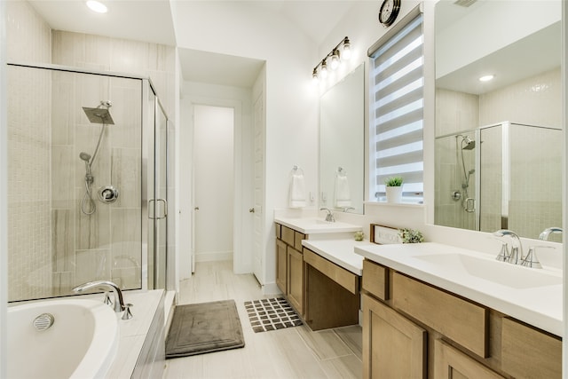 bathroom with tile patterned flooring, dual bowl vanity, and separate shower and tub