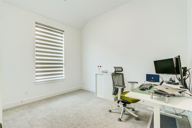 carpeted office with lofted ceiling