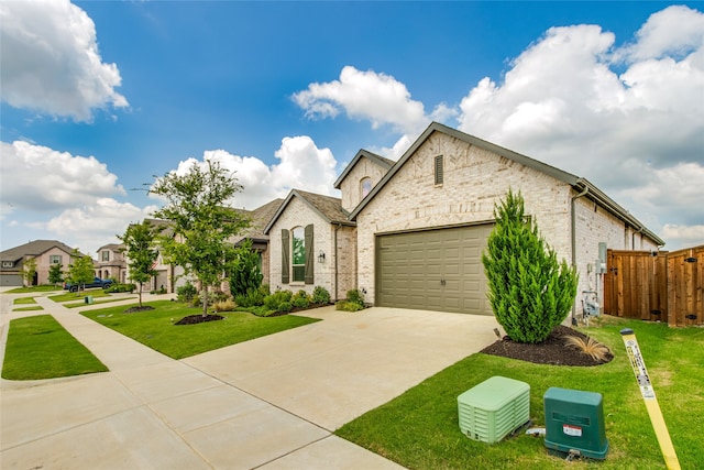 french country style house with a garage and a front lawn