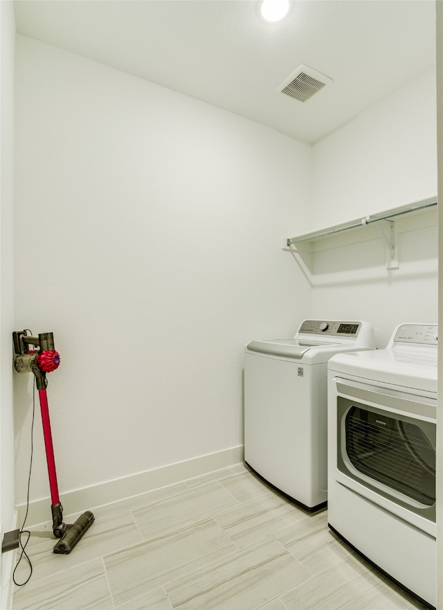 clothes washing area featuring independent washer and dryer