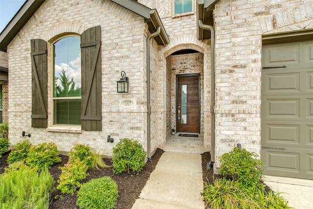 view of exterior entry with a garage