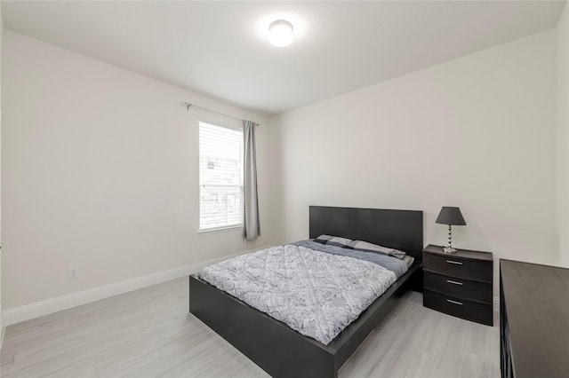 bedroom featuring light wood-type flooring and baseboards
