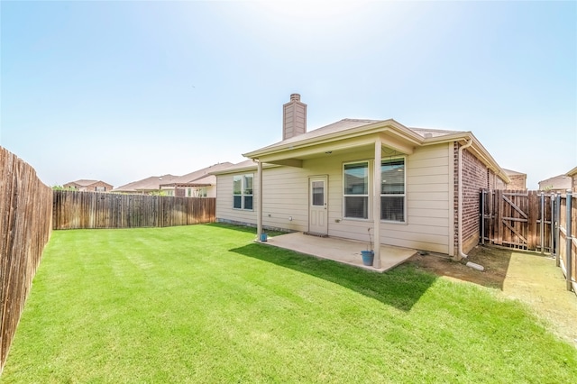 rear view of house with a patio area and a lawn