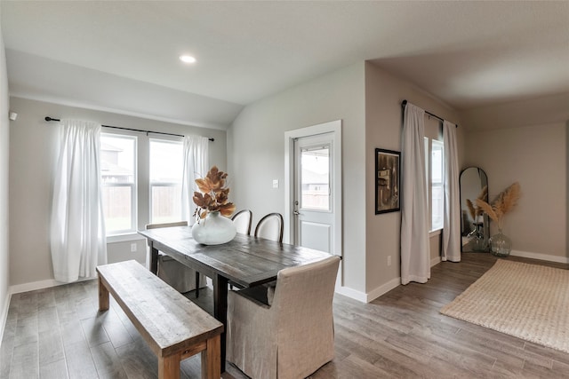 dining space with lofted ceiling and hardwood / wood-style floors