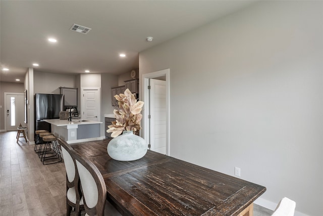 dining room featuring light hardwood / wood-style floors and sink