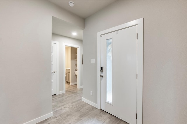 entryway featuring light wood-type flooring and baseboards