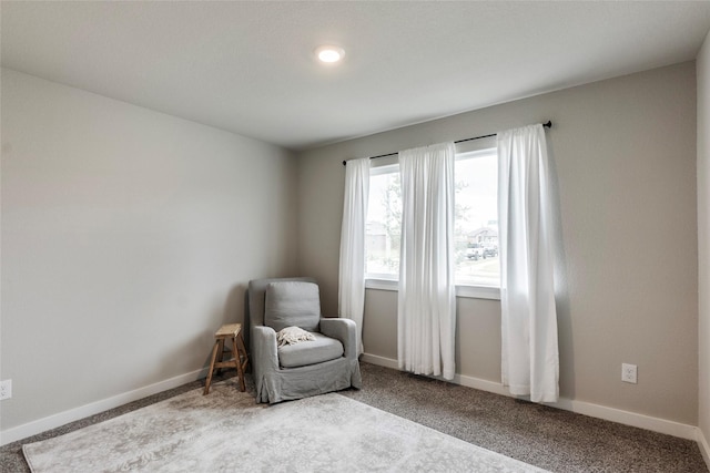 unfurnished room with carpet and baseboards