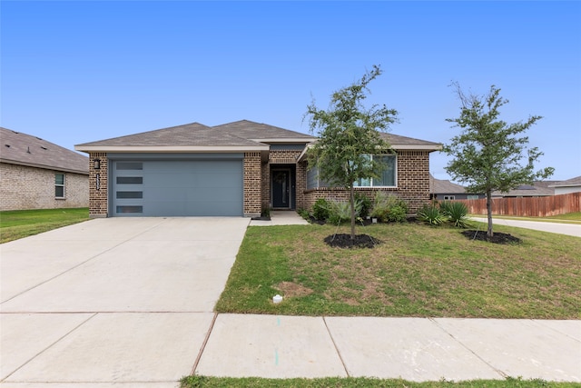 single story home featuring a garage and a front lawn