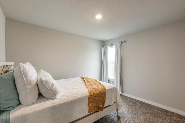 carpeted bedroom featuring baseboards