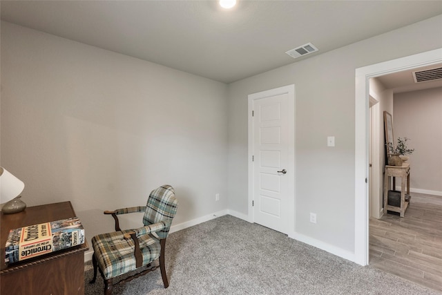 office space with light colored carpet, visible vents, and baseboards