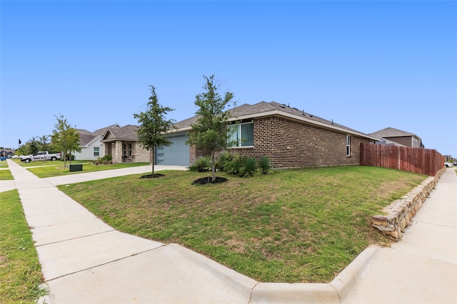 view of front of house featuring a garage and a front yard