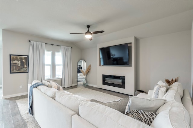 living room featuring lofted ceiling, light hardwood / wood-style flooring, and ceiling fan