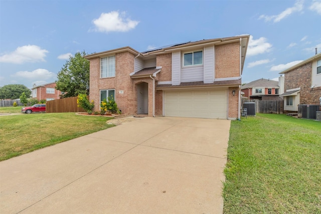 view of front of property with a garage, central AC, and a front yard