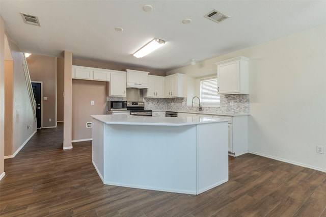 kitchen featuring white cabinetry, a kitchen island, dark hardwood / wood-style floors, and appliances with stainless steel finishes