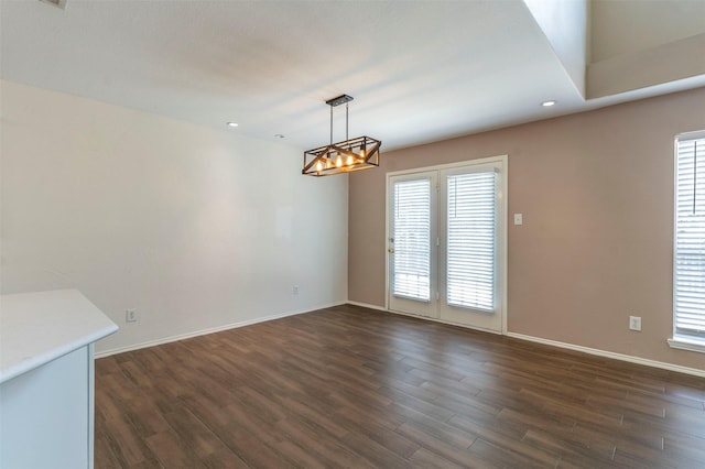 unfurnished dining area with dark hardwood / wood-style floors