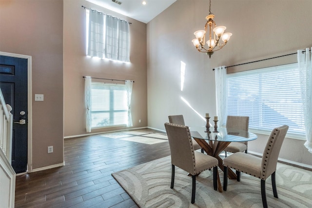 dining space featuring a notable chandelier, dark hardwood / wood-style floors, and high vaulted ceiling