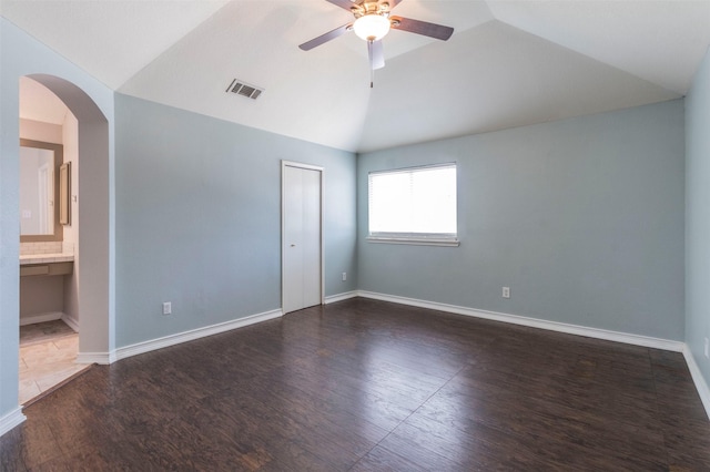 unfurnished room with ceiling fan, dark wood-type flooring, and lofted ceiling