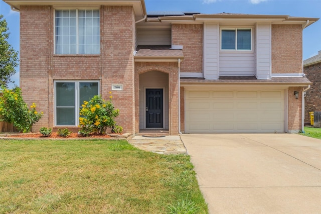 view of front of home with a garage and a front lawn