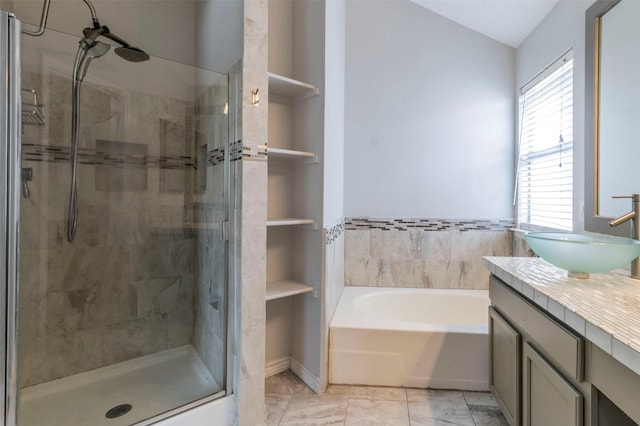 bathroom with vanity and separate shower and tub