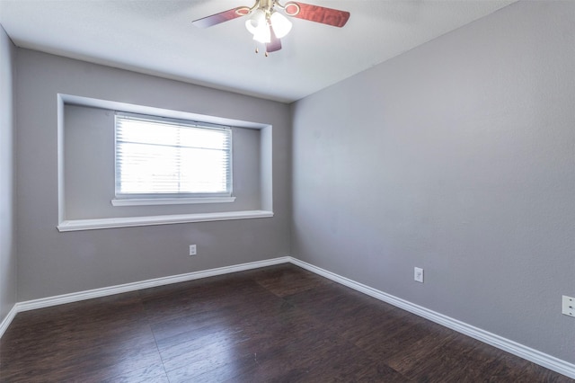 empty room with dark hardwood / wood-style floors and ceiling fan