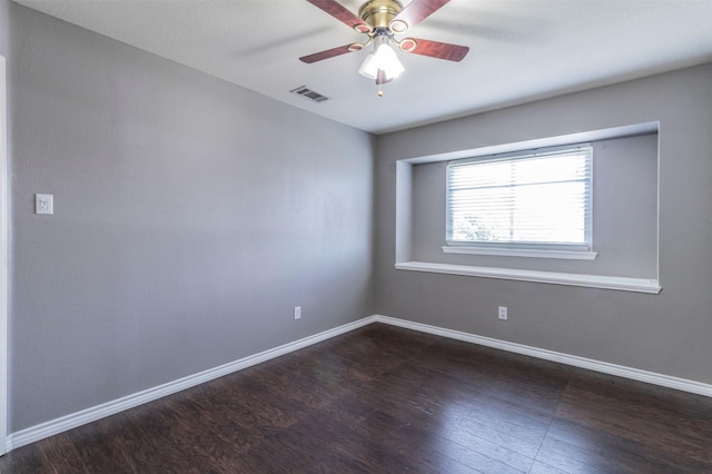 empty room with ceiling fan and dark hardwood / wood-style floors