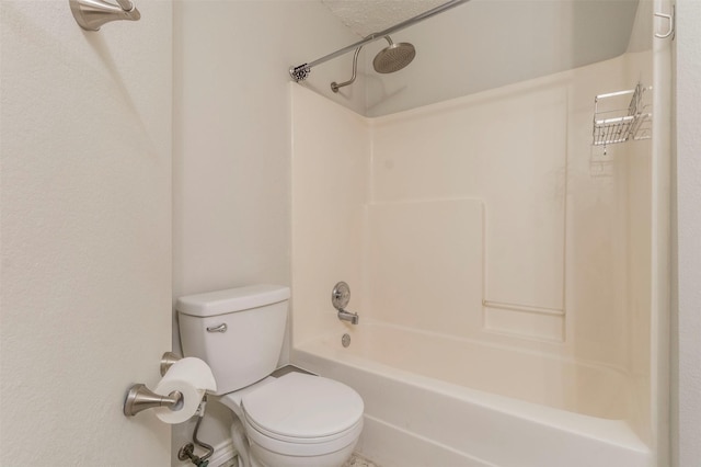 bathroom featuring washtub / shower combination, a textured ceiling, and toilet