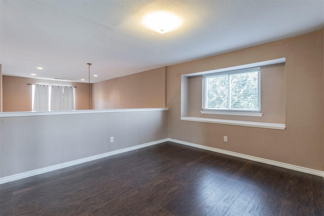 empty room with dark hardwood / wood-style floors