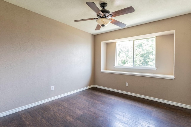 spare room featuring ceiling fan and dark hardwood / wood-style flooring