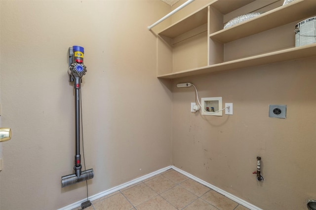 laundry area featuring light tile patterned flooring, washer hookup, hookup for an electric dryer, and hookup for a gas dryer