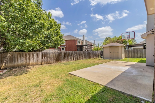 view of yard featuring a storage unit and a patio