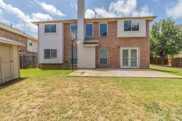 rear view of house featuring a yard and a patio area