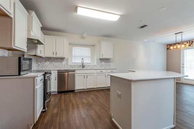 kitchen with white cabinetry, a center island, dark wood-type flooring, and appliances with stainless steel finishes