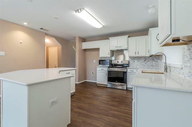 kitchen featuring stainless steel appliances, sink, a center island, dark hardwood / wood-style floors, and white cabinetry