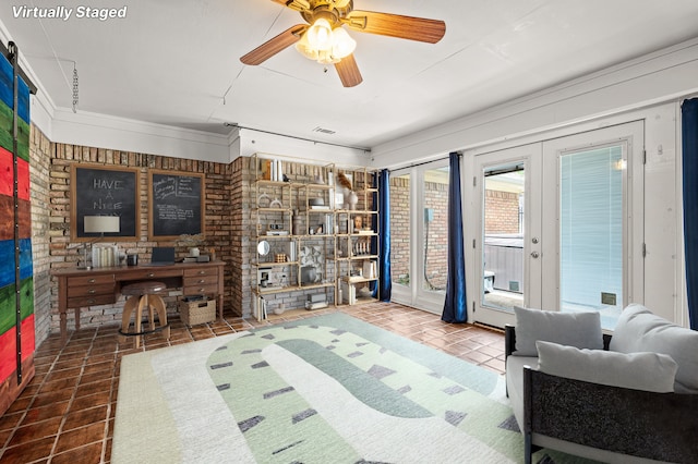 tiled living room with ceiling fan and brick wall