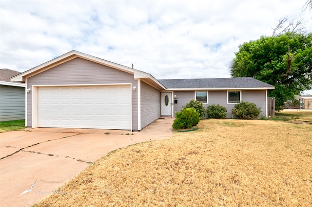 single story home featuring a garage and a front lawn