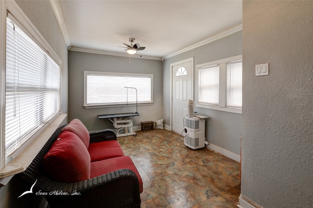 tiled living room with ceiling fan and crown molding