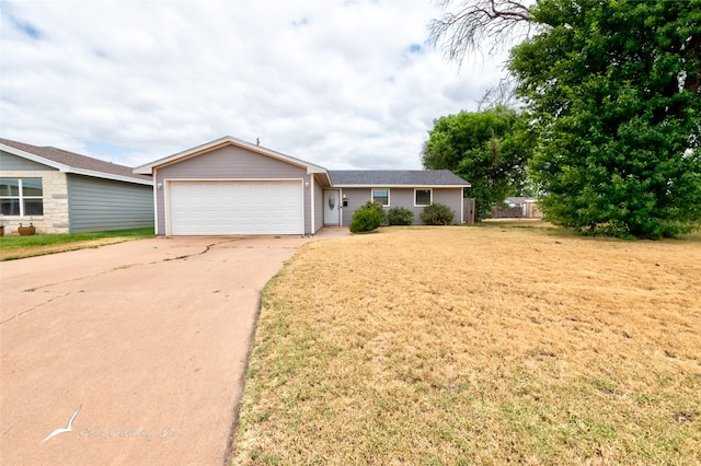 ranch-style home featuring a garage and a front yard