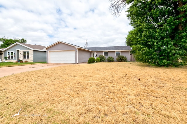 ranch-style house with a garage and a front lawn